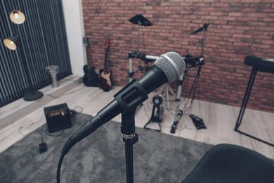 Photo of Musical instruments in studio, focus on microphone