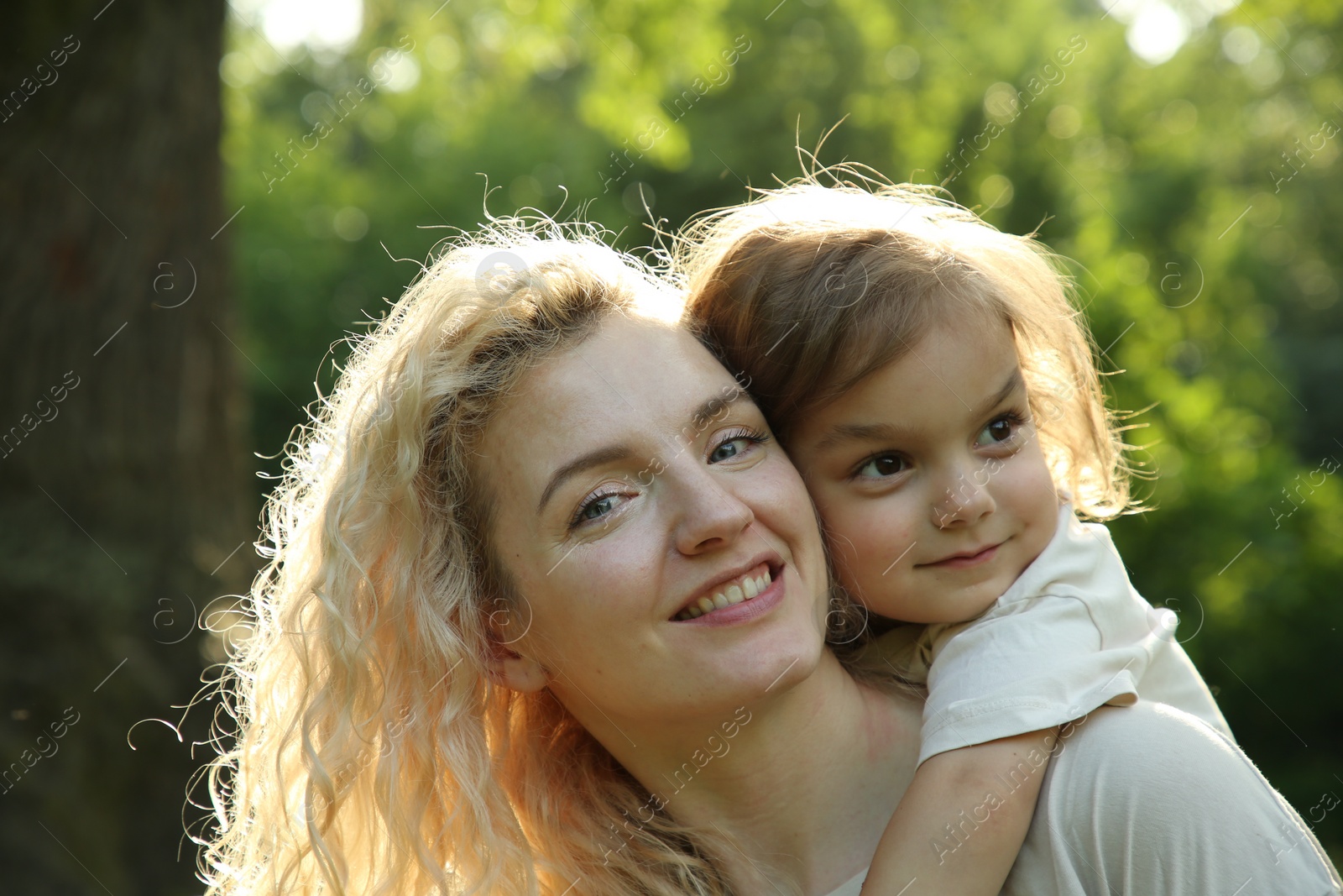 Photo of Happy woman with her daughter spending time together outdoors