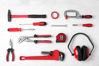 Photo of Flat lay composition with construction tools on white wooden background