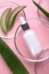 Photo of Flat lay composition with aloe vera leaves and cosmetic products on pink background