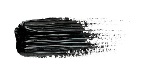 Photo of Brushstroke of black oil paint on white background, top view