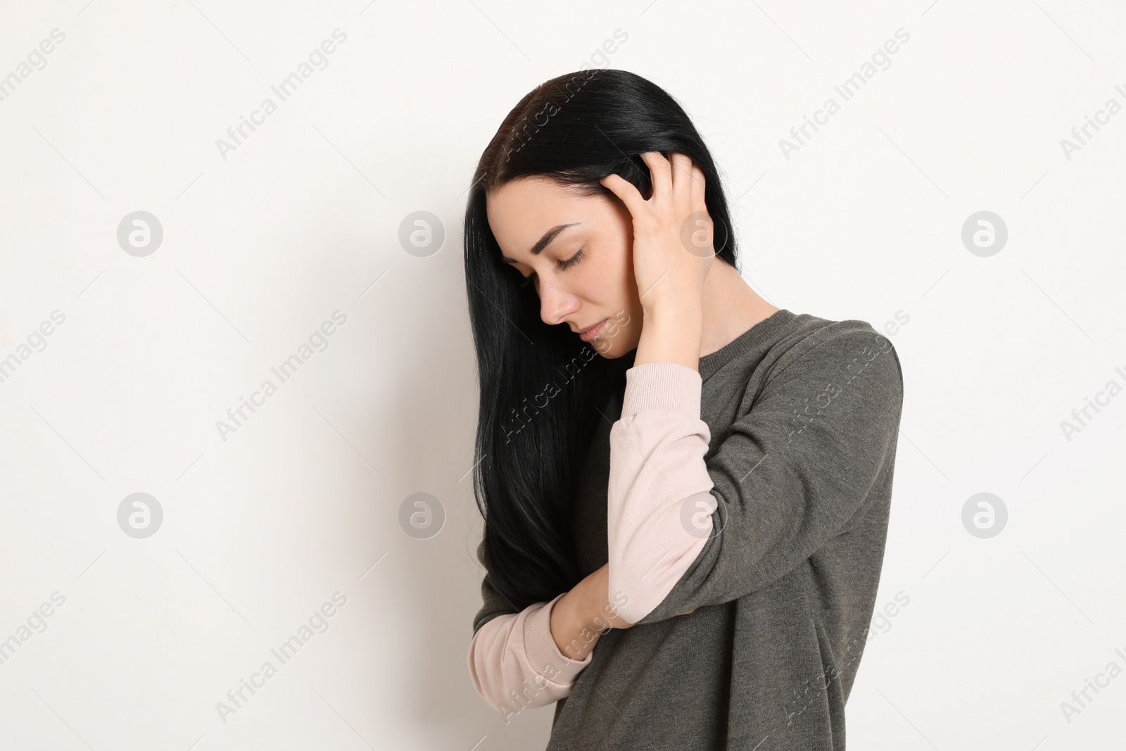 Photo of Portrait of upset young woman on white background. Space for text