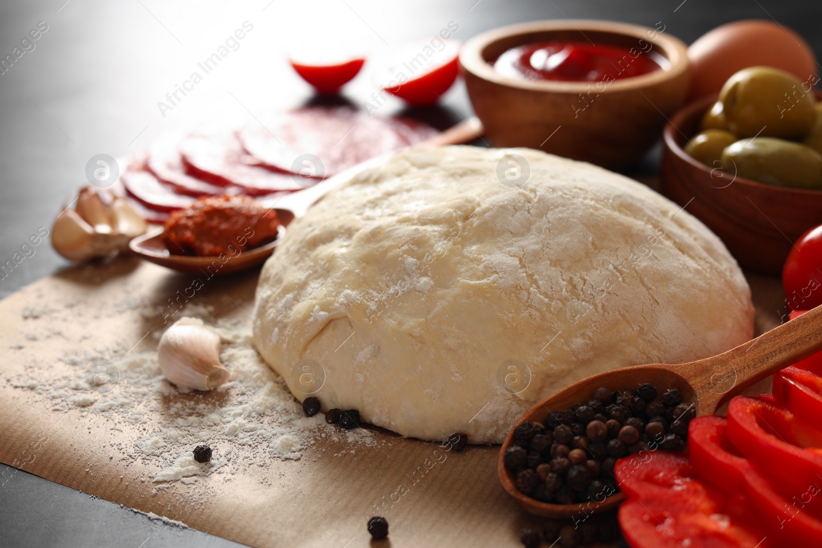 Photo of Pizza dough and products on table, closeup