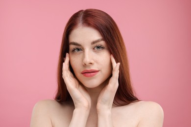 Photo of Portrait of beautiful woman with freckles on pink background