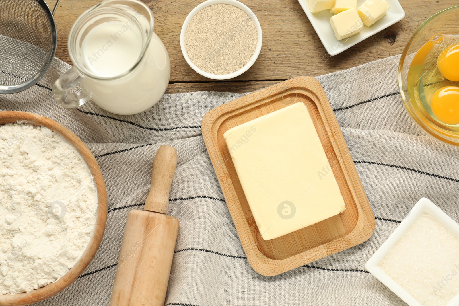 Photo of Flat lay composition with fresh butter and other products on wooden table