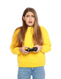 Emotional young woman playing video games with controller isolated on white