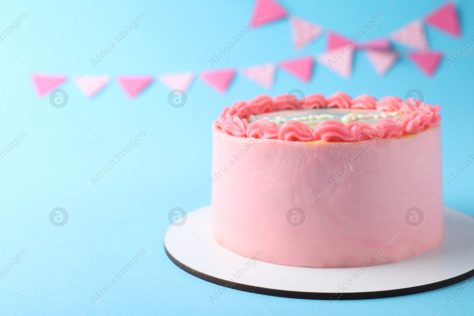 Photo of Cute bento cake with tasty cream on light blue background, space for text