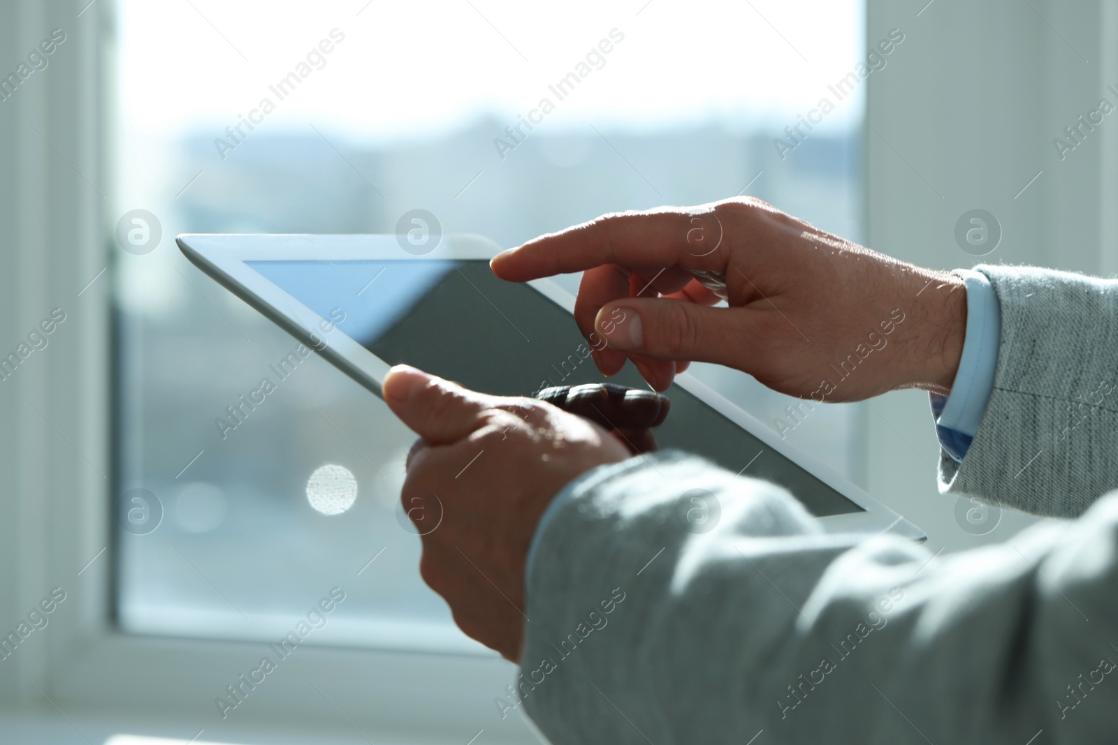 Photo of Closeup view of man using new tablet indoors