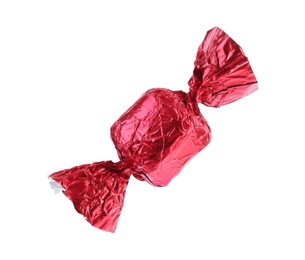 Photo of Tasty candy in red wrapper isolated on white