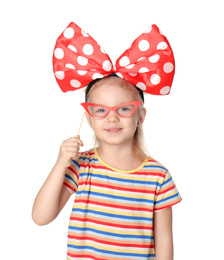 Photo of Little girl with large bow and funny glasses on white background. April fool's day