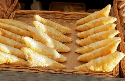 Photo of Tray with fresh puff pastry turnovers on bakery showcase