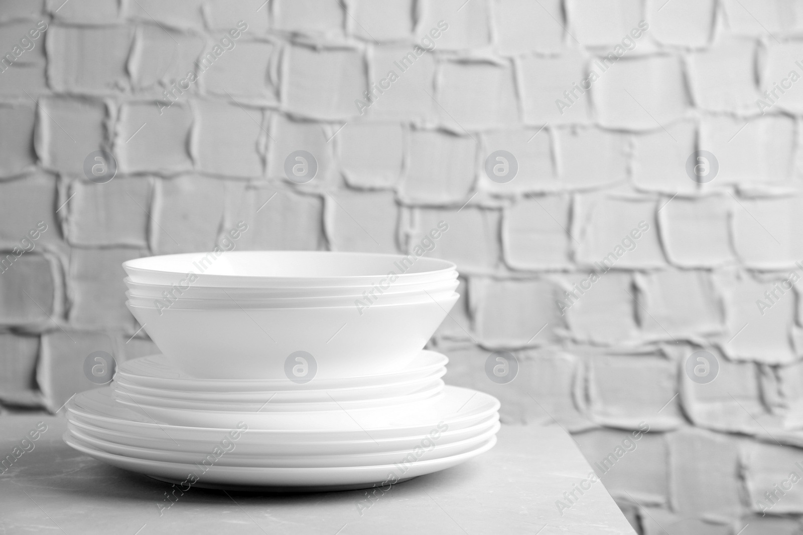 Photo of Stack of clean plates on table