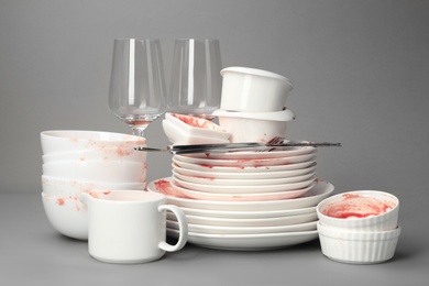 Photo of Set of dirty dishes on grey background