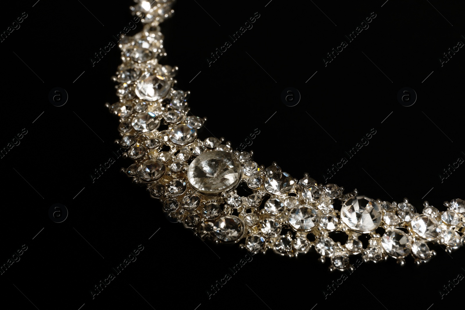 Photo of Stylish necklace on black background, closeup. Luxury jewelry