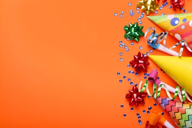 Photo of Flat lay composition with accessories for birthday party on orange background. Space for text