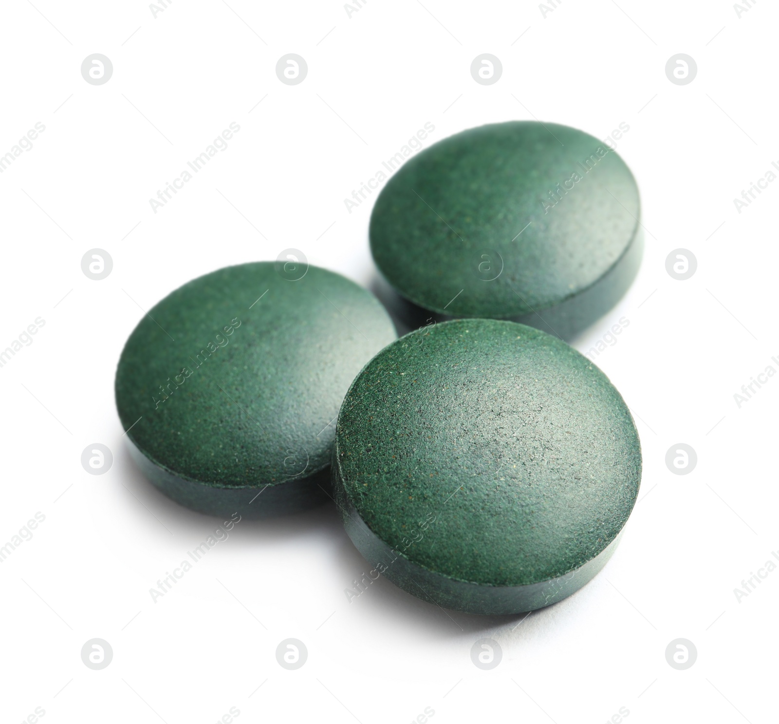 Photo of Spirulina tablets on white background. Healthy lifestyle