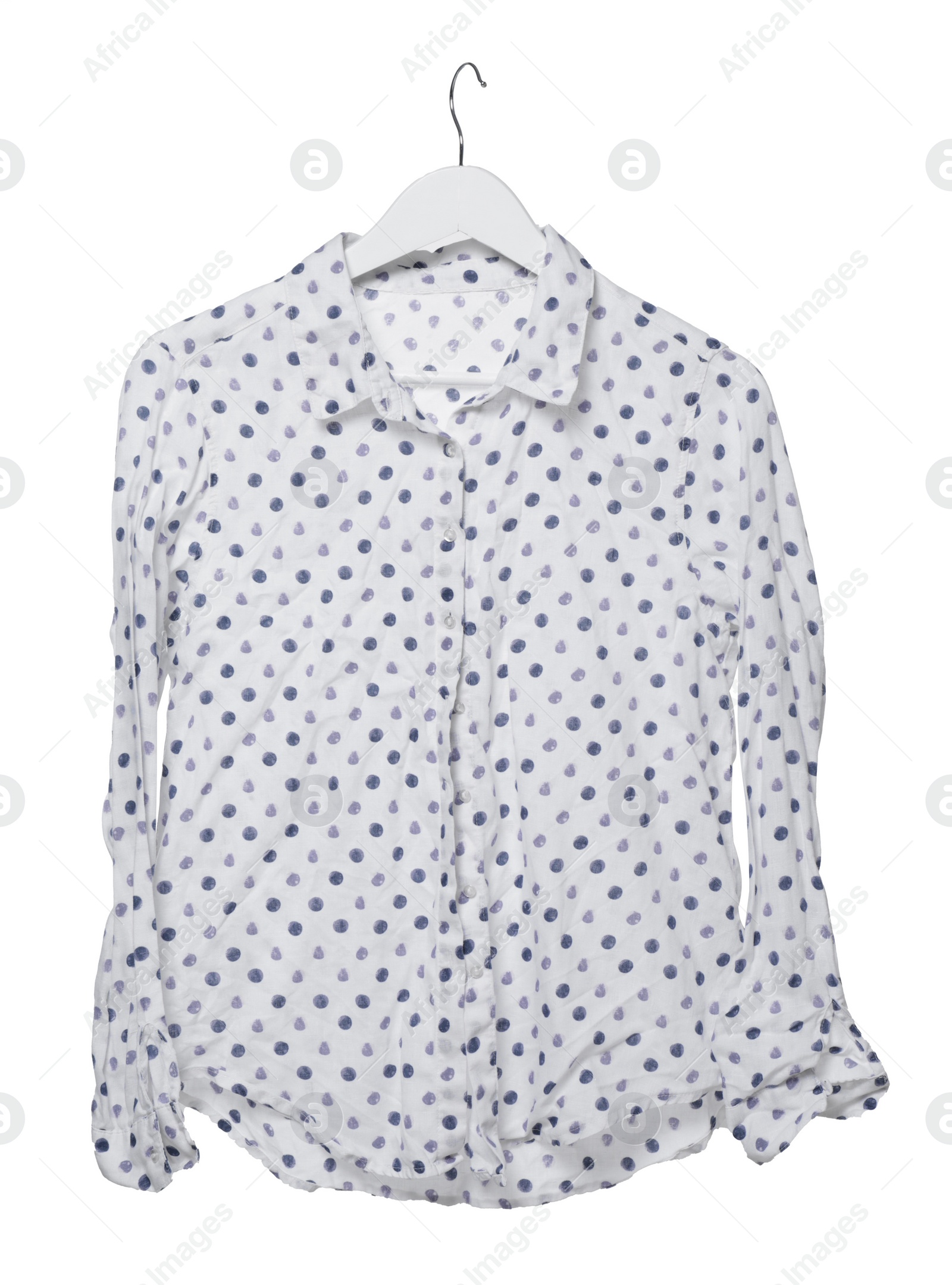 Photo of Crumpled polka dot blouse on hanger against white background