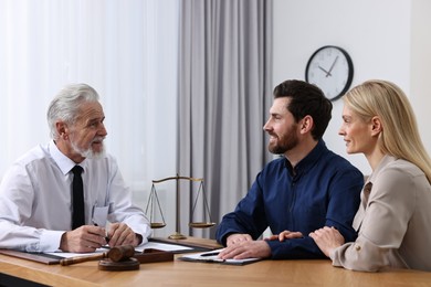 Photo of Couple having meeting with lawyer in office