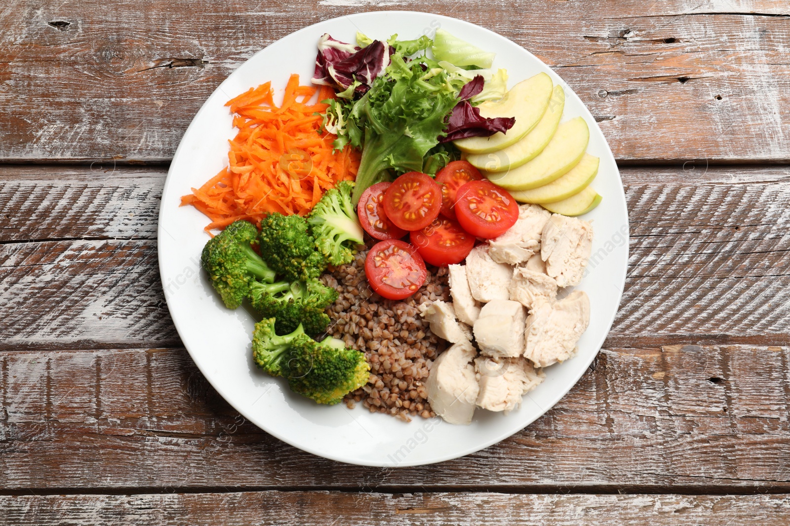 Photo of Balanced diet and healthy foods. Plate with different delicious products on wooden table, top view