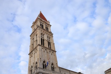 Photo of Trogir, Croatia - September 24, 2023: Beautiful Cathedral against cloudy sky, low angle view