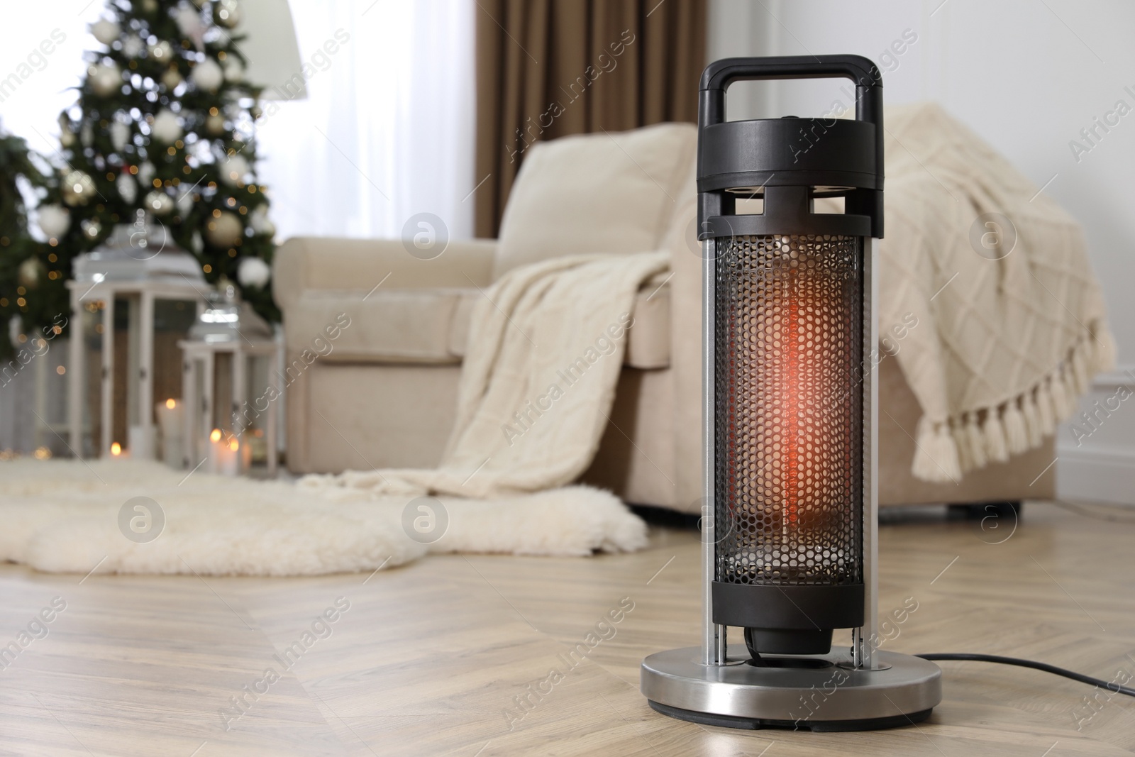 Photo of Modern electric heater on floor at home. Space for text