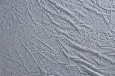 Crumpled white fabric as background, top view