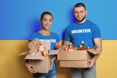 Image of Volunteers holding donation boxes with Ukrainian flag on background. Help during war