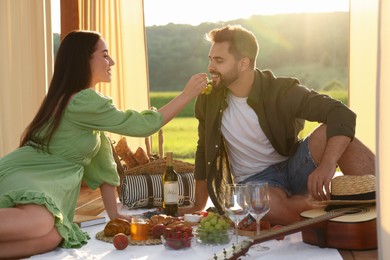 Romantic date. Beautiful couple having picnic outdoors on sunny day