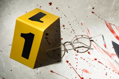 Photo of Crime scene marker, glasses and blood on light grey marble background, above view