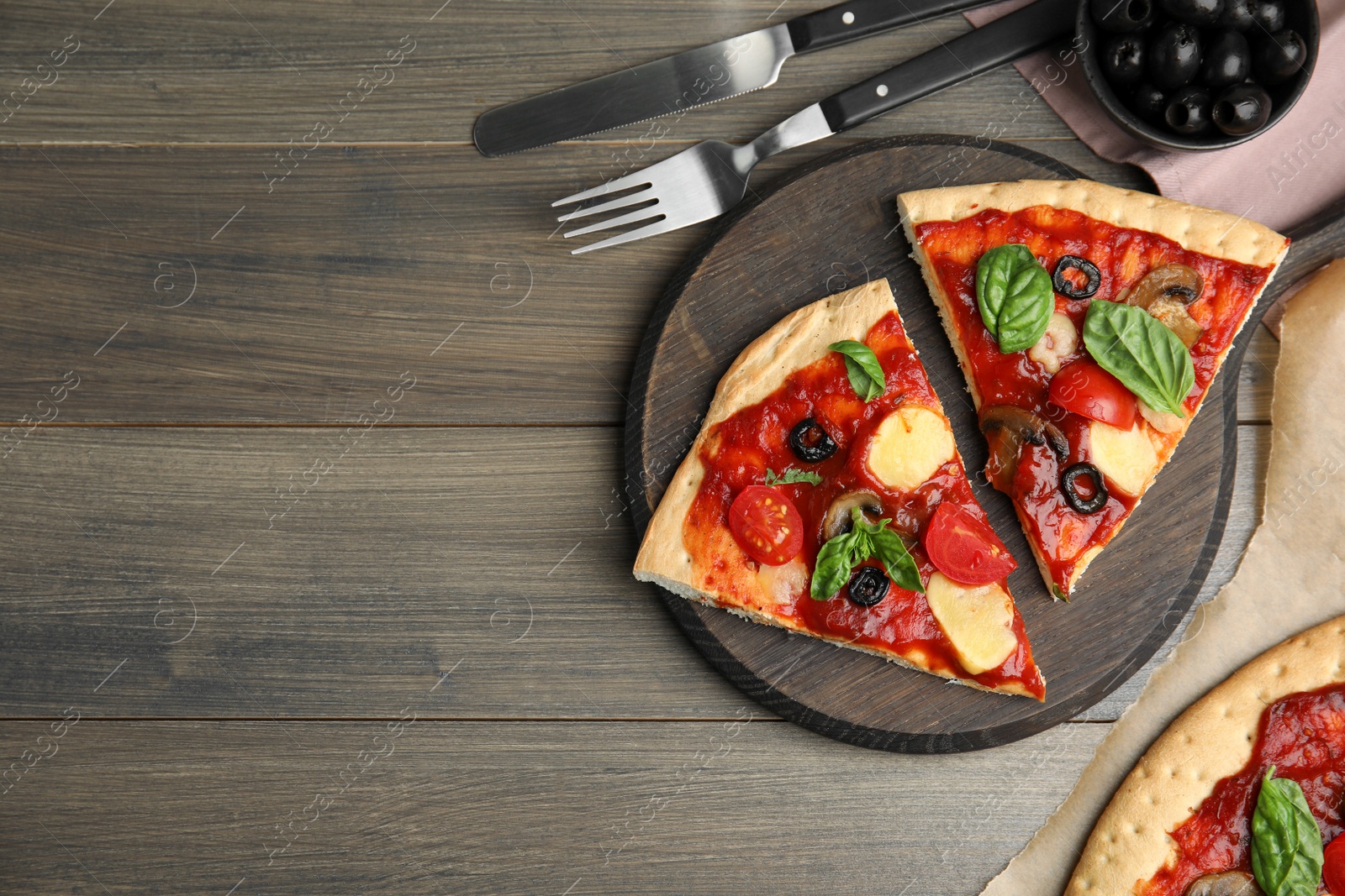 Photo of Slices of delicious pita pizza on wooden table, flat lay. Space for text