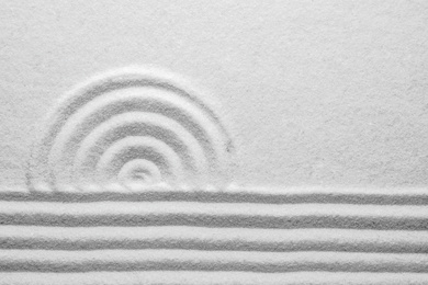 Photo of White sand with pattern as background, top view. Zen, meditation, harmony