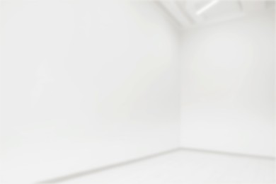 Image of Empty room with white walls, blurred view