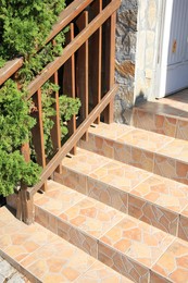 View of beautiful stone stairs with metal handrail near house outdoors