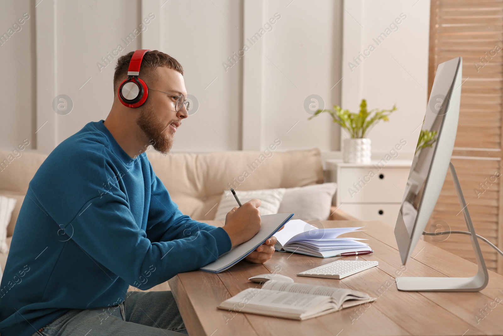 Photo of Online test. Man studying with computer at home