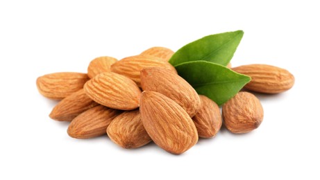 Photo of Organic almond nuts and green leaves on white background. Healthy snack