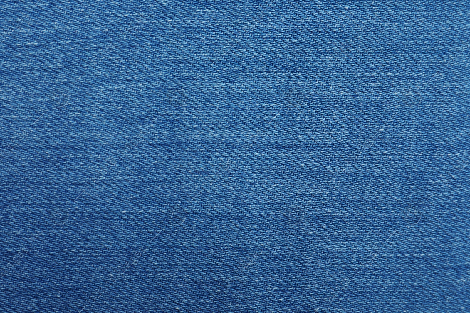 Photo of Texture of blue jeans as background, closeup