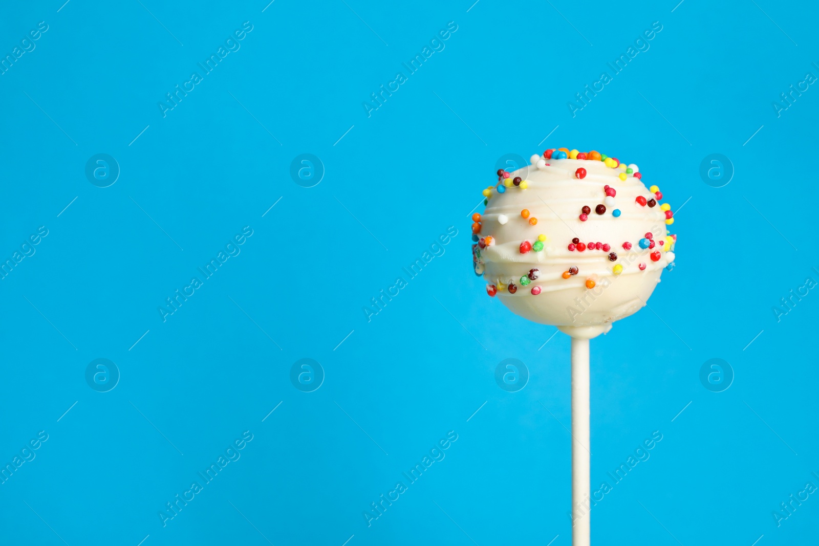 Photo of Bright delicious cake pop on color background. Space for text