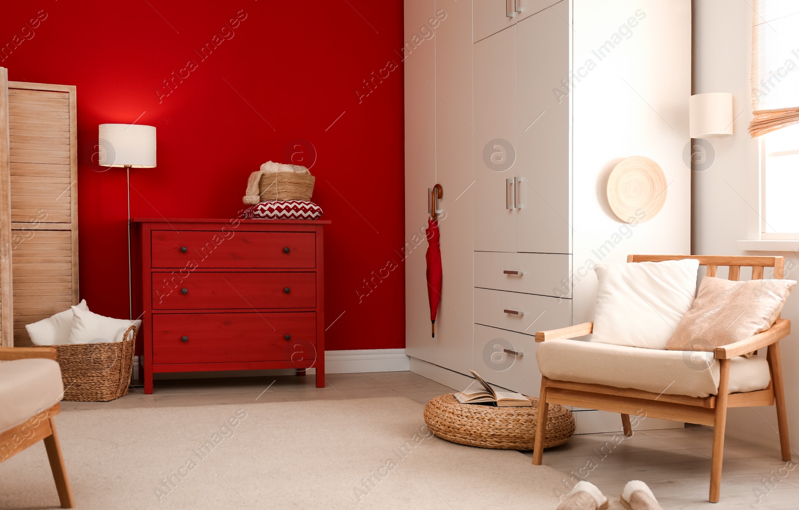 Photo of Modern room interior with red chest of drawers