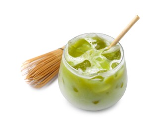 Photo of Glass of tasty iced matcha latte and bamboo whisk on white tiled table, closeup