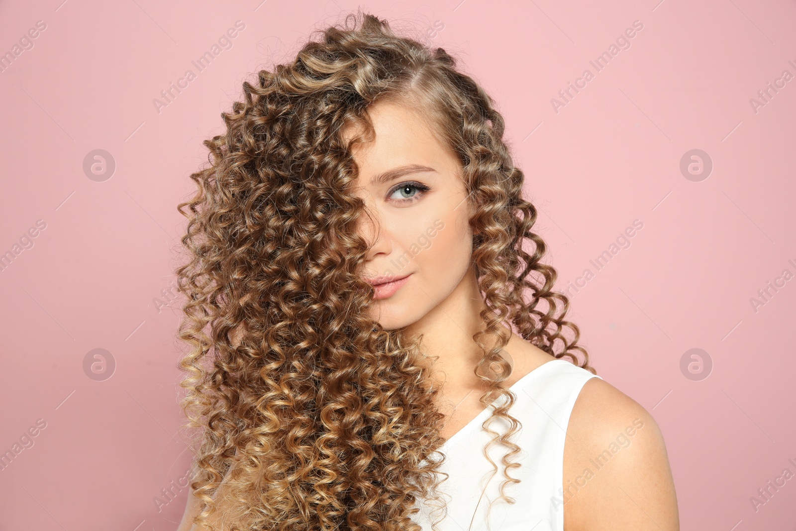 Photo of Portrait of beautiful young woman with shiny wavy hair on color background