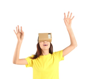 Young woman using cardboard virtual reality headset, isolated on white