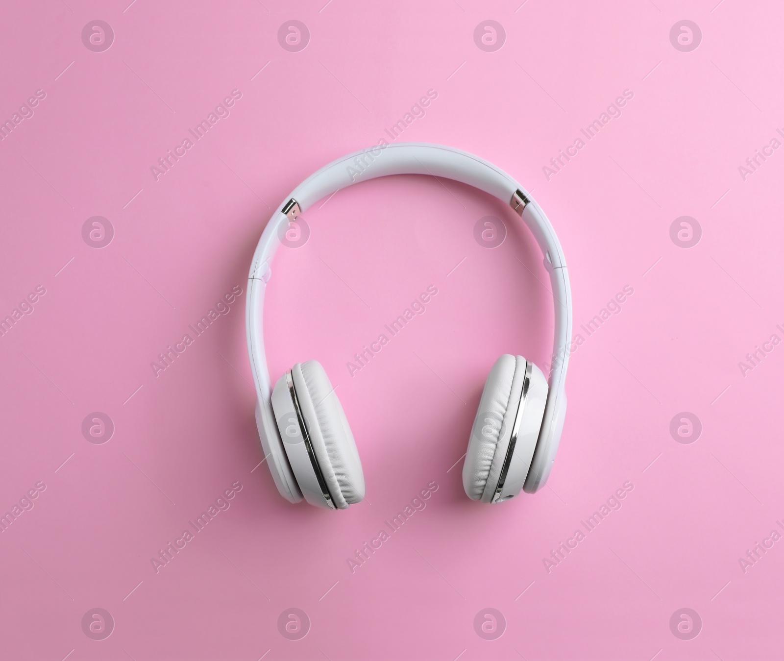 Photo of Wireless headphones on color background, top view