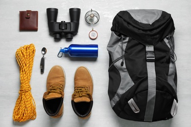 Photo of Flat lay composition with different camping equipment on light background