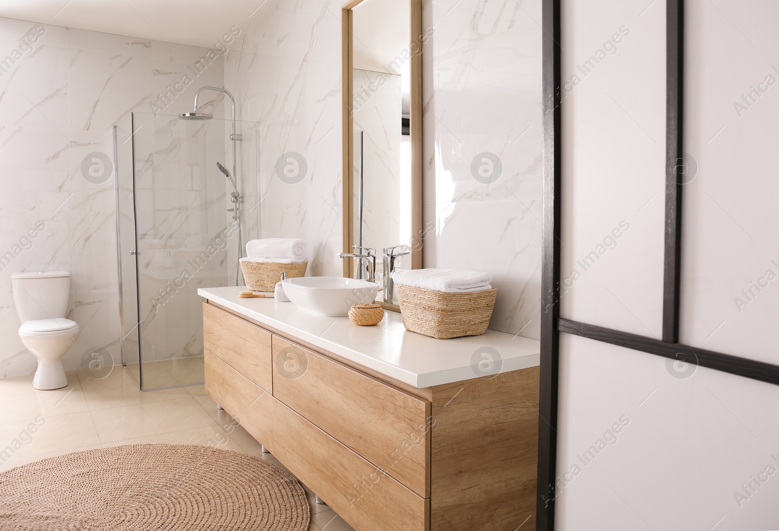 Photo of Large mirror and vessel sink in bathroom