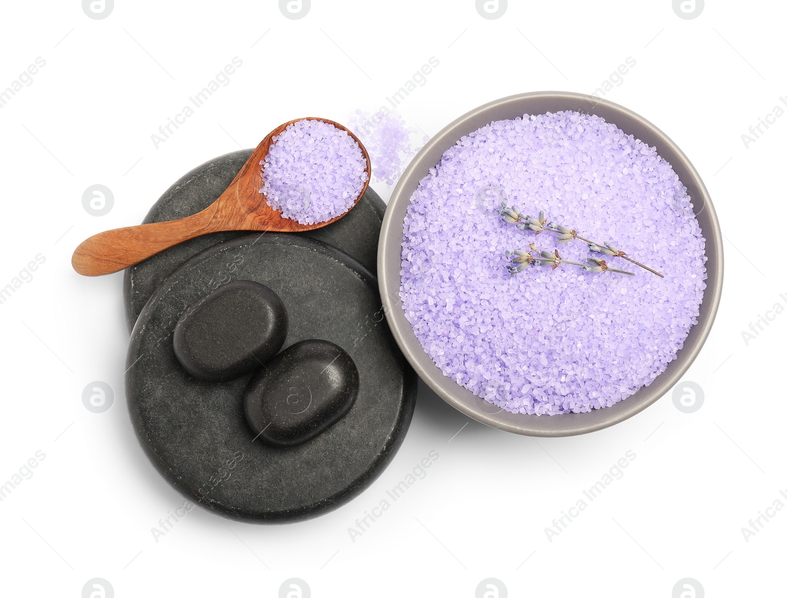 Photo of Violet sea salt in bowl, spa stones, spoon and lavender flowers isolated on white, top view