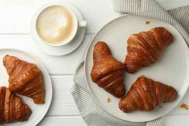 Photo of Flat lay composition with tasty croissants and cup of hot drink on white wooden table