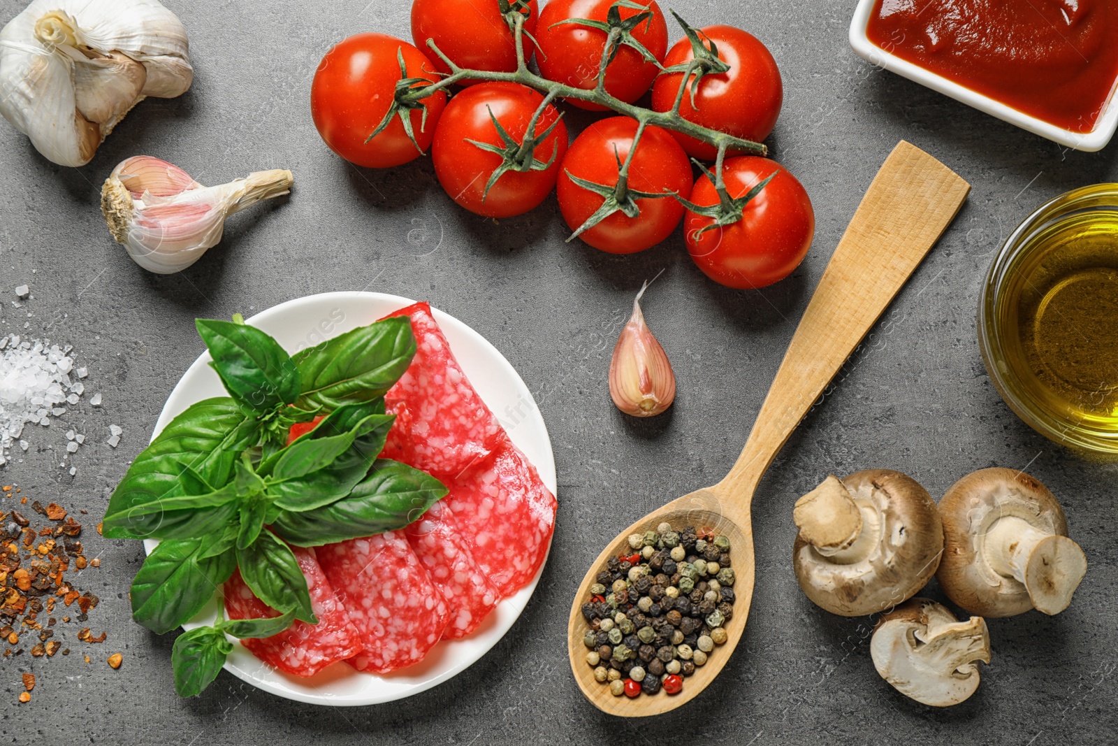 Photo of Flat lay composition with fresh ingredients for pizza on grey table