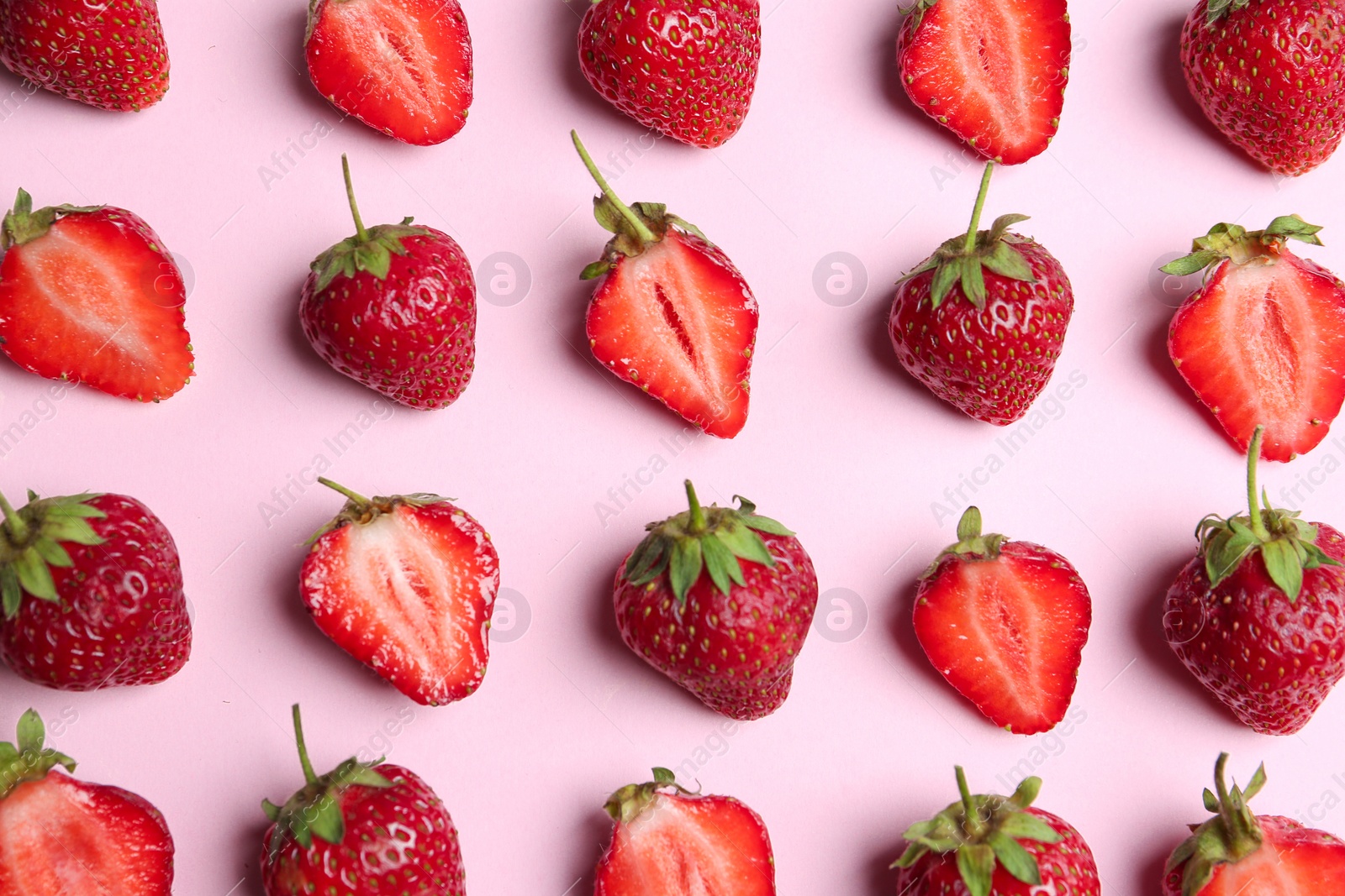 Photo of Tasty ripe strawberries on pink background, flat lay