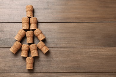 Christmas tree made of wine corks on wooden table, top view. Space for text