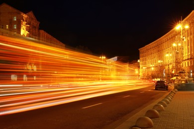 Road traffic, motion blur effect. View of night cityscape with car light trails